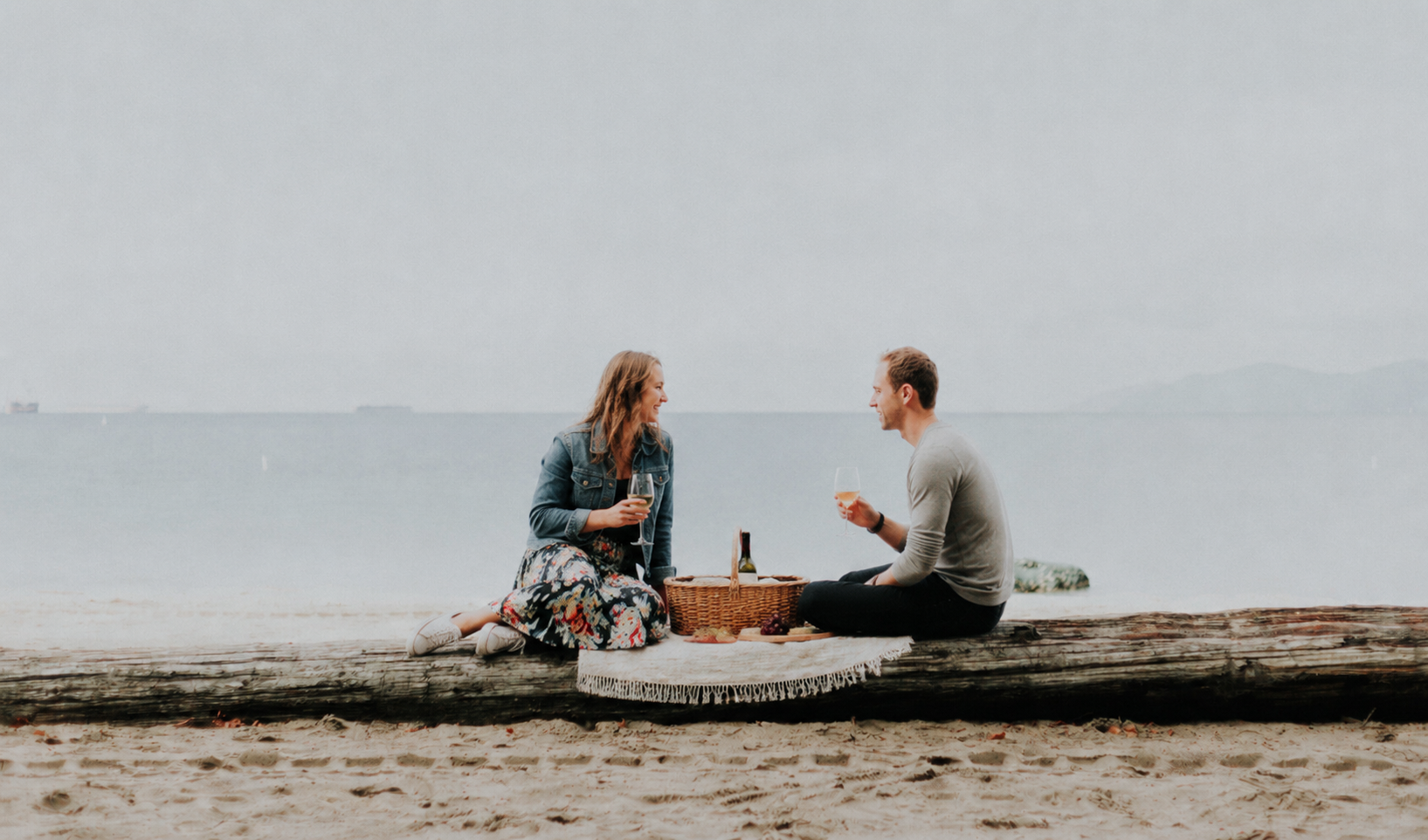 Couple enjoying a beach picnic together